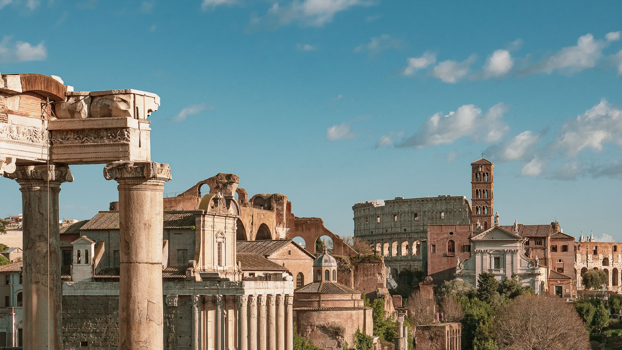 Photo of the Forum and the Colosseum in the background in Rome, capital of Italy