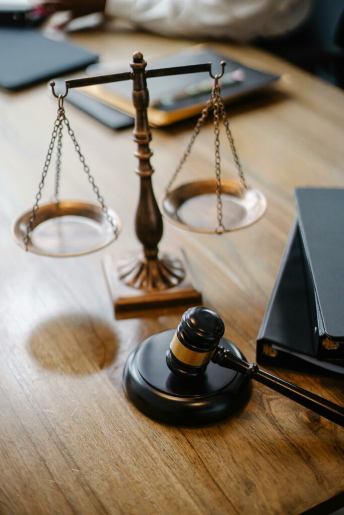 Concept of Law symbolized by the scale and the gavel on a desk