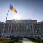 Photo of the Romanian parliament with a flag in front of it, in Bucharest, capital of Romania